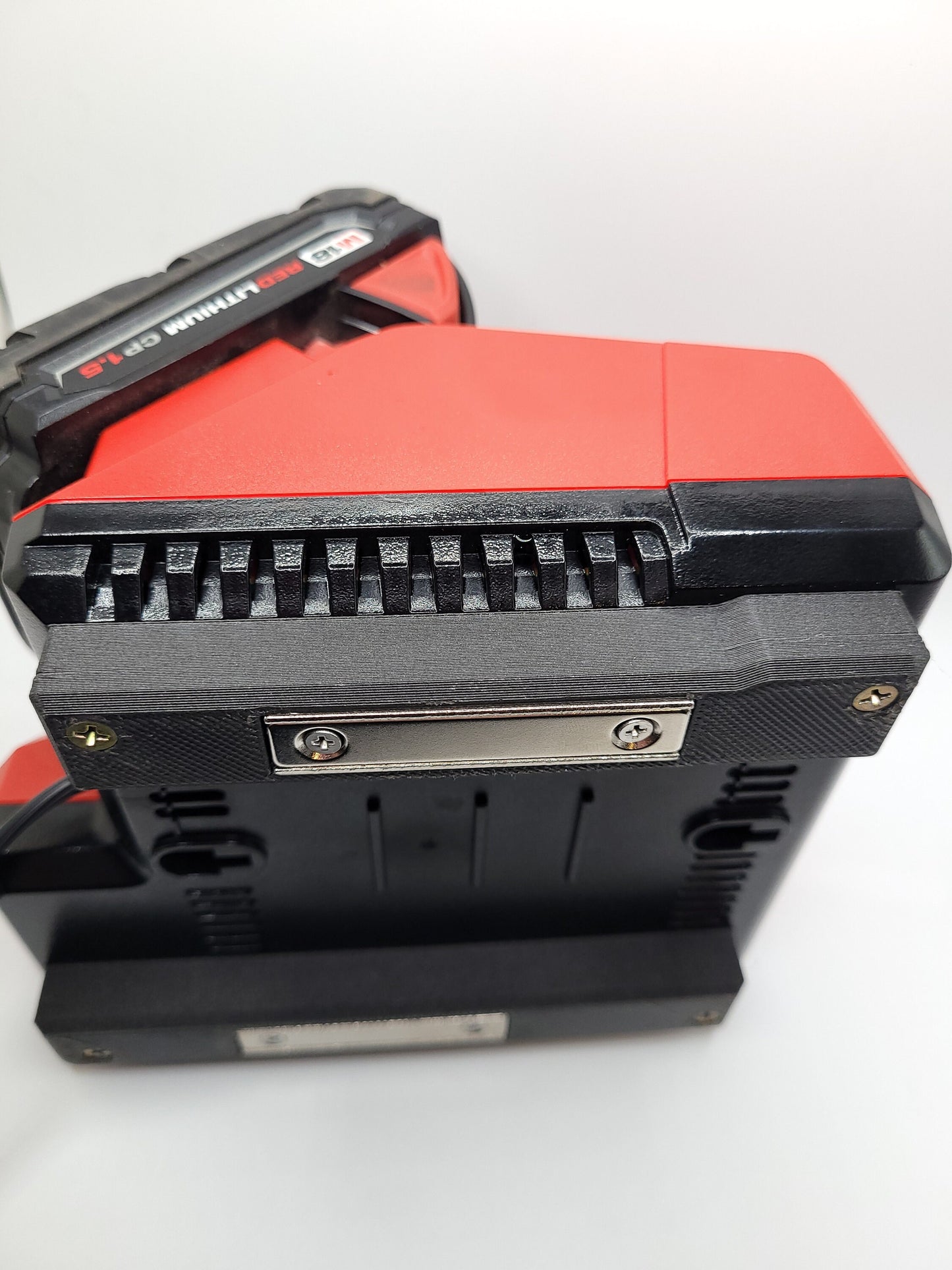 Milwaukee M12 M18 Charger Mount, Cat. No. 48-59-1812, Uses Two Neodymium Bar Magnets for Strong Hold on Metal Surface